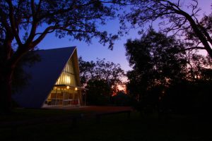 An image of The Abbey A-Frame facility at twilight