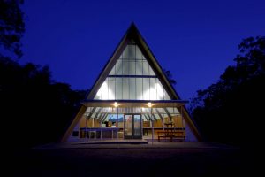 An image of The Abbey A-Frame facility at twilight