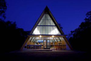 An image of The Abbey A-Frame facility at twilight